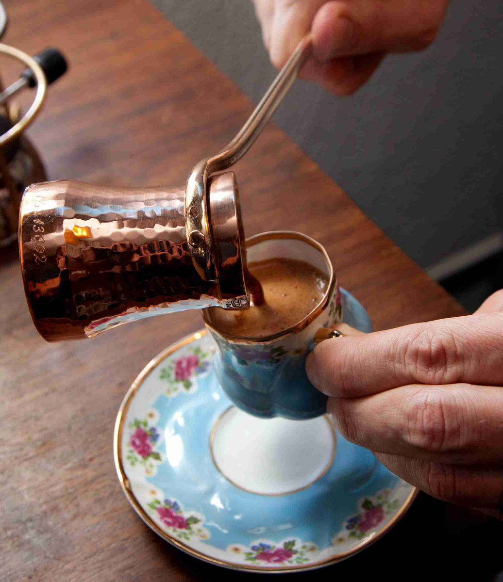 Turkish Coffee being poured from a copper cezve