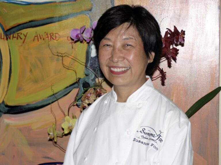 Susanna Foo in front of artwork